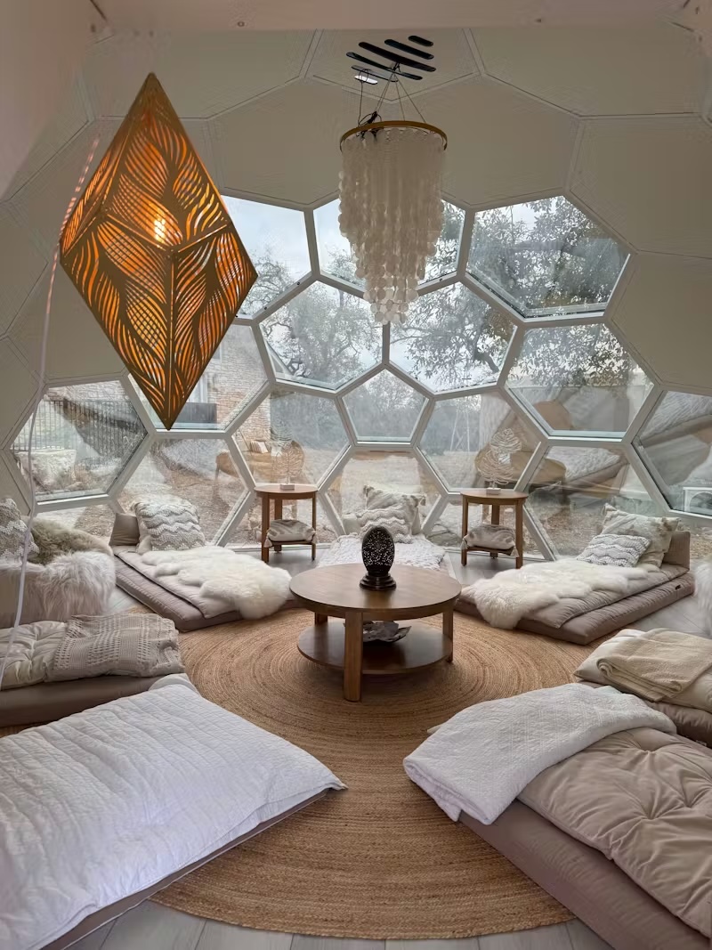 Honeycomb dome ceremony space with cushions and natural light